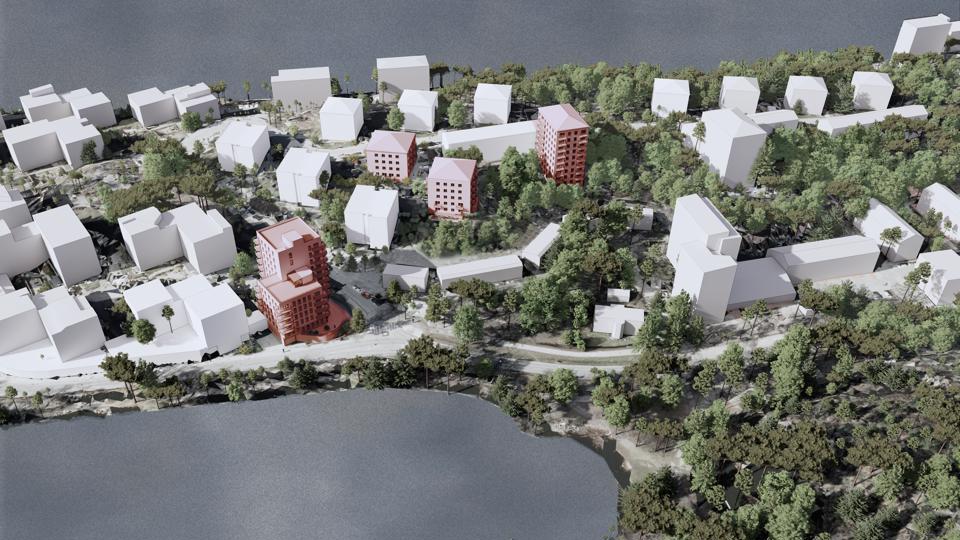 3D illustration. Flygvy över Ekensberg från söder med Gröndalsvägen i förgrunden. Befintliga byggnader är illustrerade med vita kuber och föreslagen bebyggelse är markerad med röd färg.